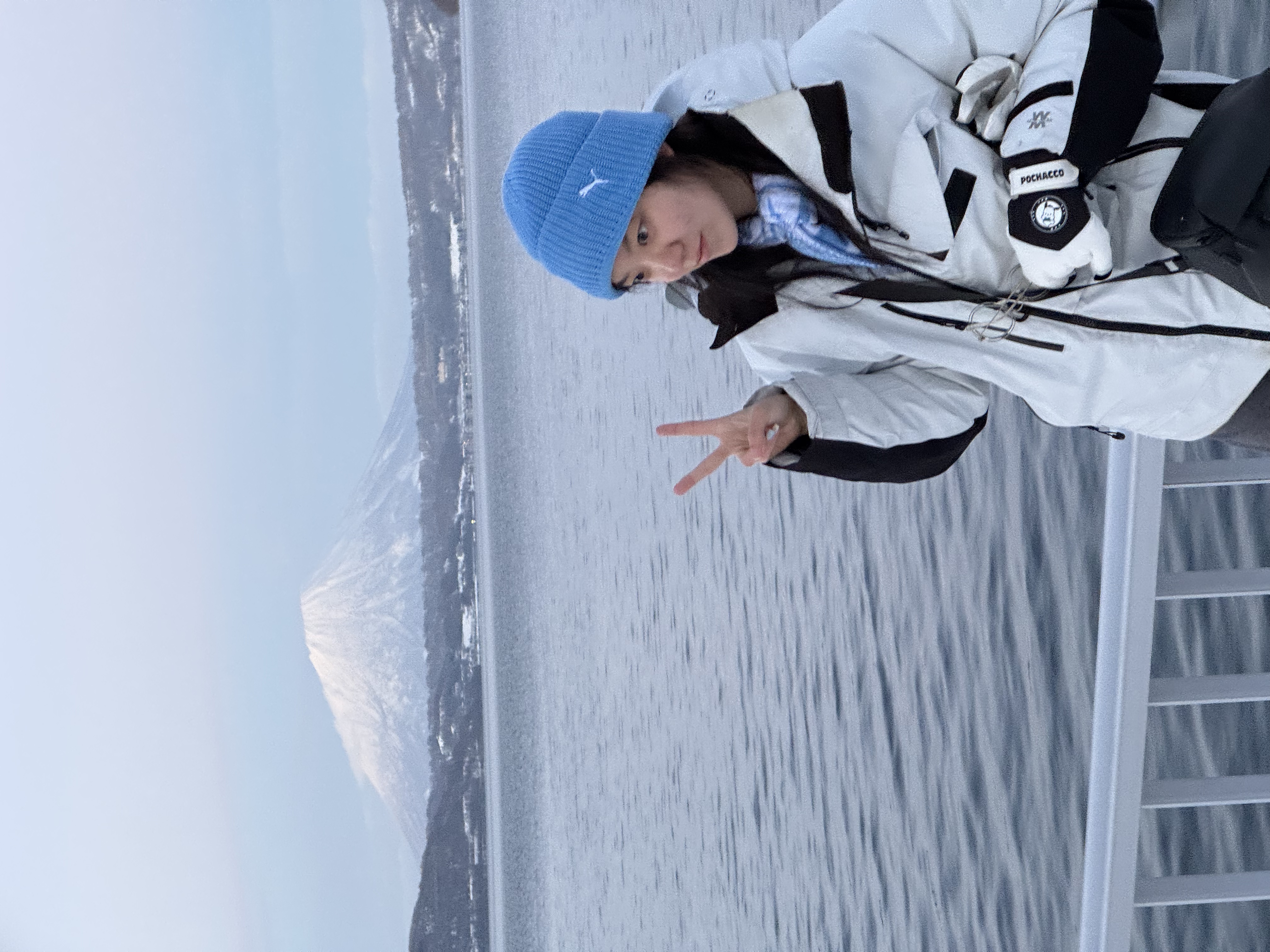 Shuqi Wang by a lake with a snow-covered mountain in the background